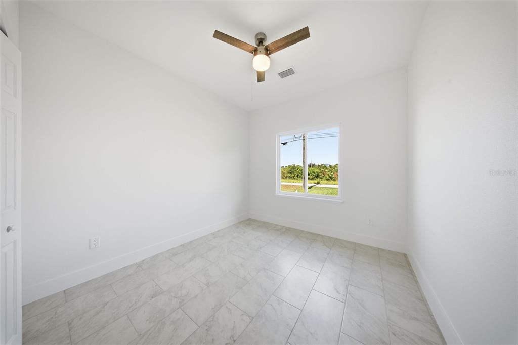 10458 Pendleton Avenue Englewood, FL 34224 - Photo 27 of 30 an empty room with a window and a ceiling fan