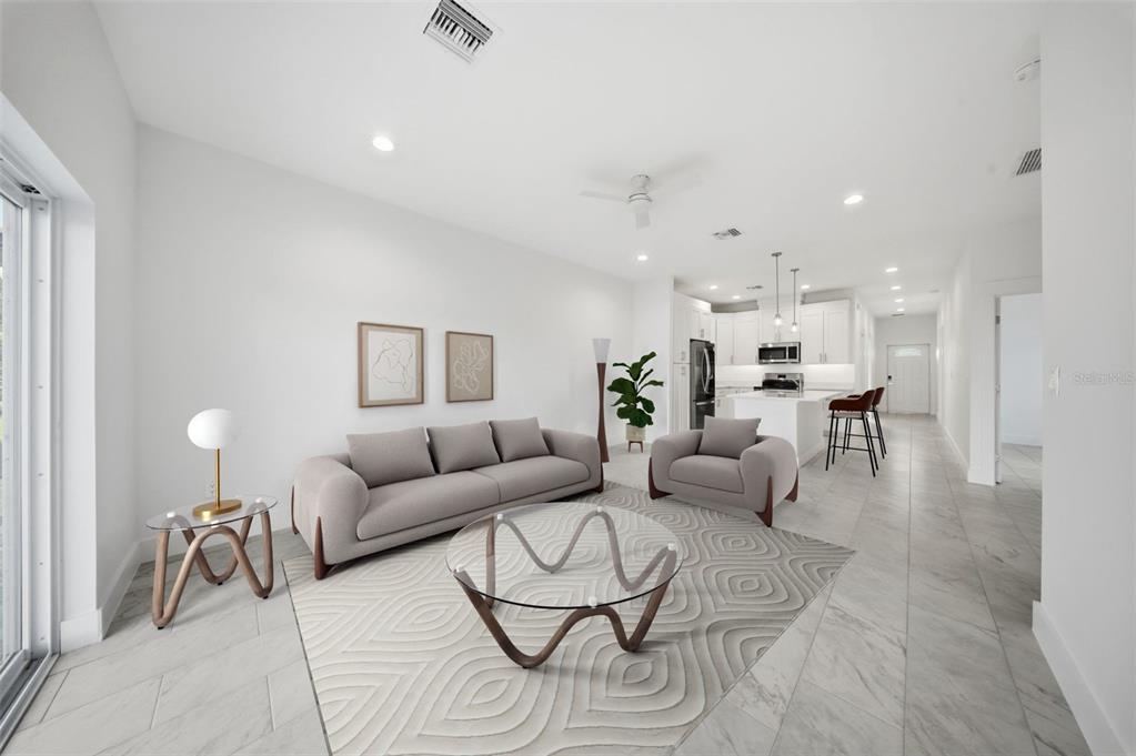 10458 Pendleton Avenue Englewood, FL 34224 - Photo 5 of 30 a living room with furniture and a dining table with wooden floor