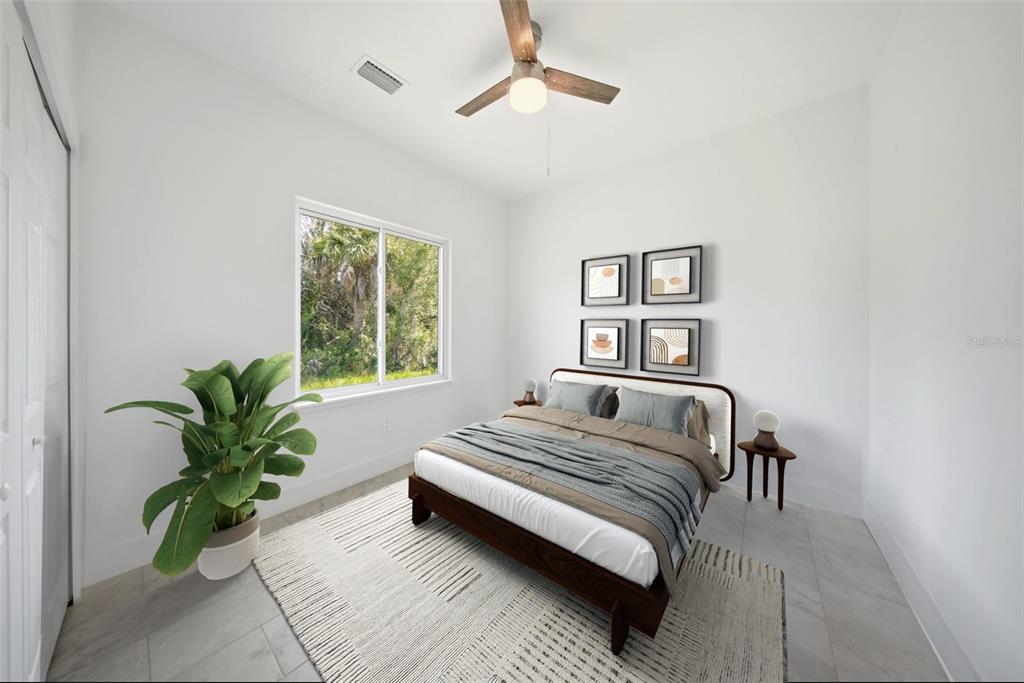 10458 Pendleton Avenue Englewood, FL 34224 - Photo 7 of 30 a bedroom with a bed and a potted plant