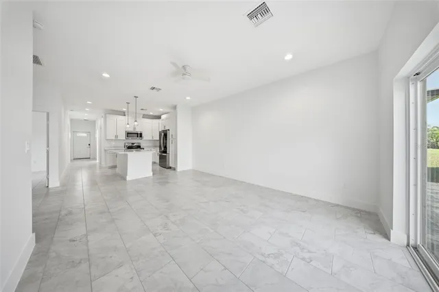 a view of a kitchen with a sink and cabinets