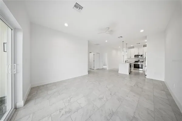a view of a kitchen with refrigerator and window