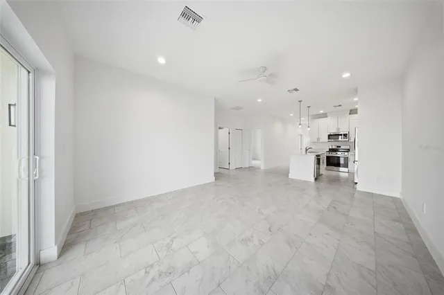 a view of a kitchen with refrigerator and window