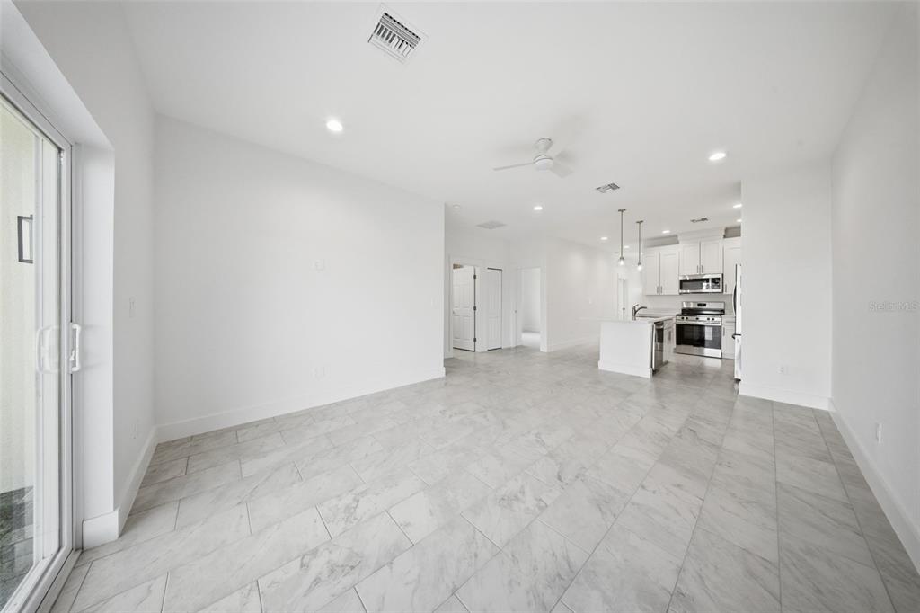 10458 Pendleton Avenue Englewood, FL 34224 - Photo 10 of 30 a view of a kitchen with refrigerator and window