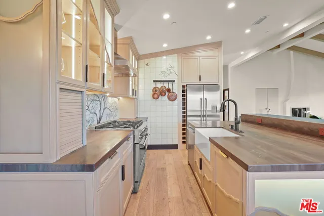 a kitchen with stainless steel appliances granite countertop a sink and cabinets