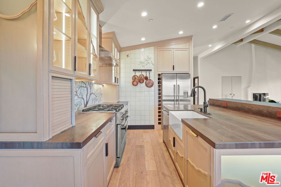 2835 Oak Point Drive Los Angeles, CA 90068 - Photo 11 of 50 a kitchen with stainless steel appliances granite countertop a sink and cabinets