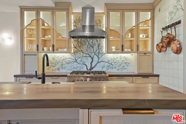 a view of a sink and mirror with large window