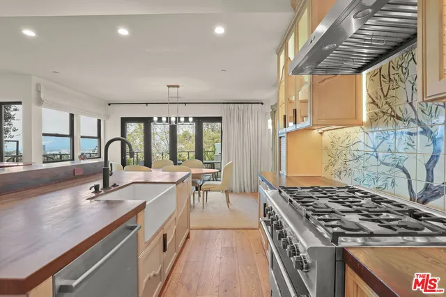 a view of kitchen with cabinets and refrigerator