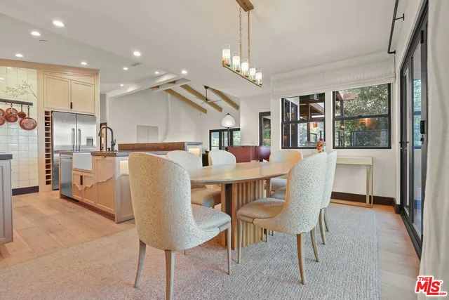 a dining room with furniture a chandelier and wooden floor