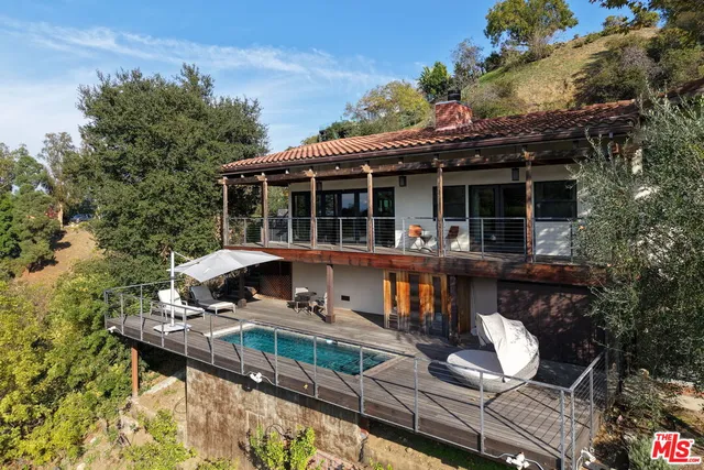 front view of house with a chairs and table in a patio