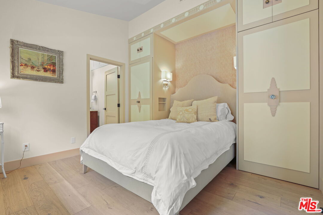 2835 Oak Point Drive Los Angeles, CA 90068 - Photo 24 of 50 a bedroom with a bed and a painting on the wall