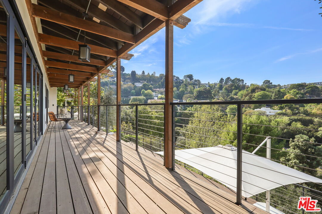 2835 Oak Point Drive Los Angeles, CA 90068 - Photo 28 of 50 a view of a balcony with lake view and a floor to ceiling window with wooden floor