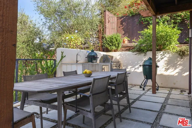 a patio with glass top table and chairs