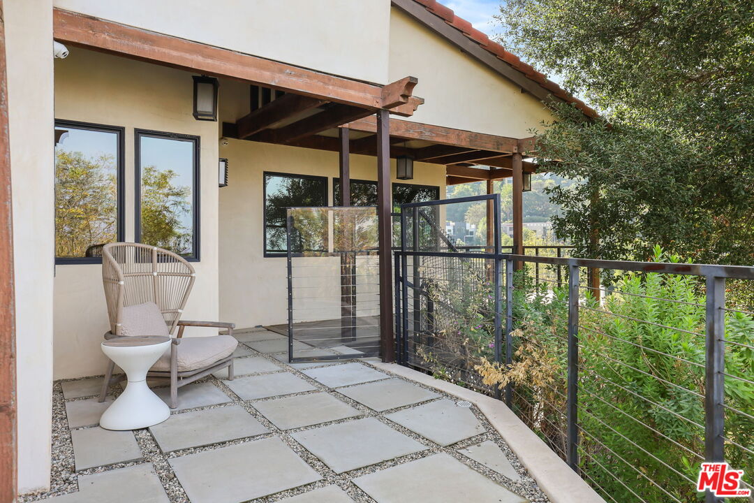 2835 Oak Point Drive Los Angeles, CA 90068 - Photo 34 of 50 a patio with glass top table and chairs