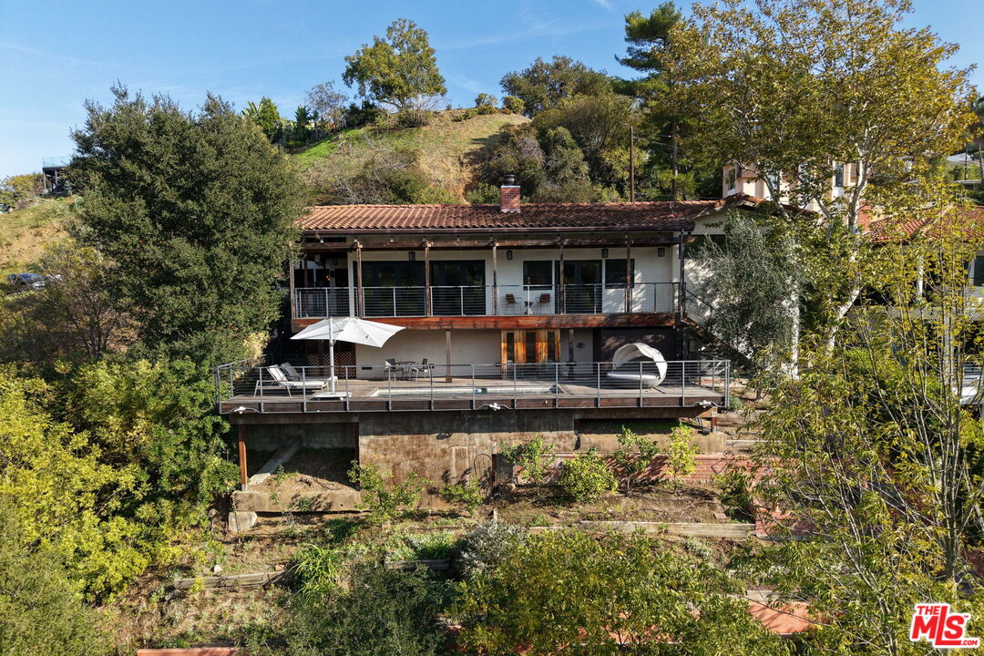 2835 Oak Point Drive Los Angeles, CA 90068 - Photo 40 of 50 a front view of a house with a yard table and chairs