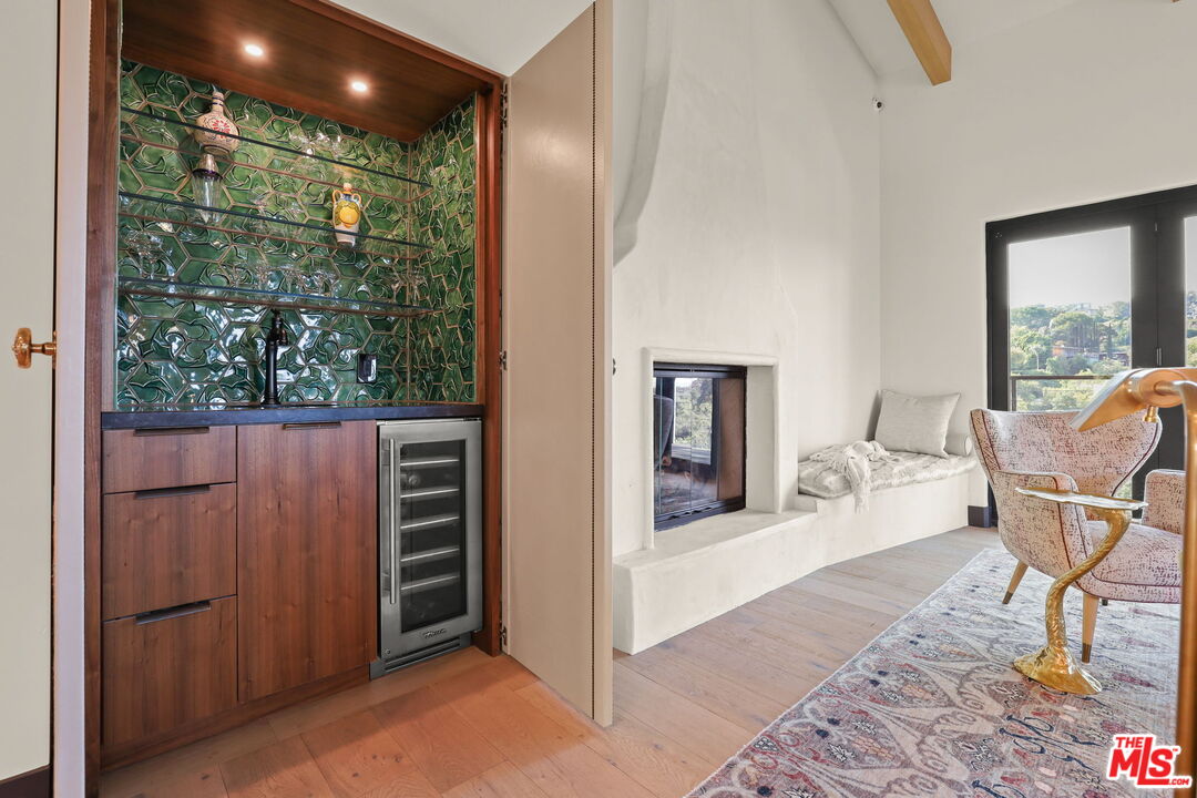 2835 Oak Point Drive Los Angeles, CA 90068 - Photo 9 of 50 a balcony with table and chairs