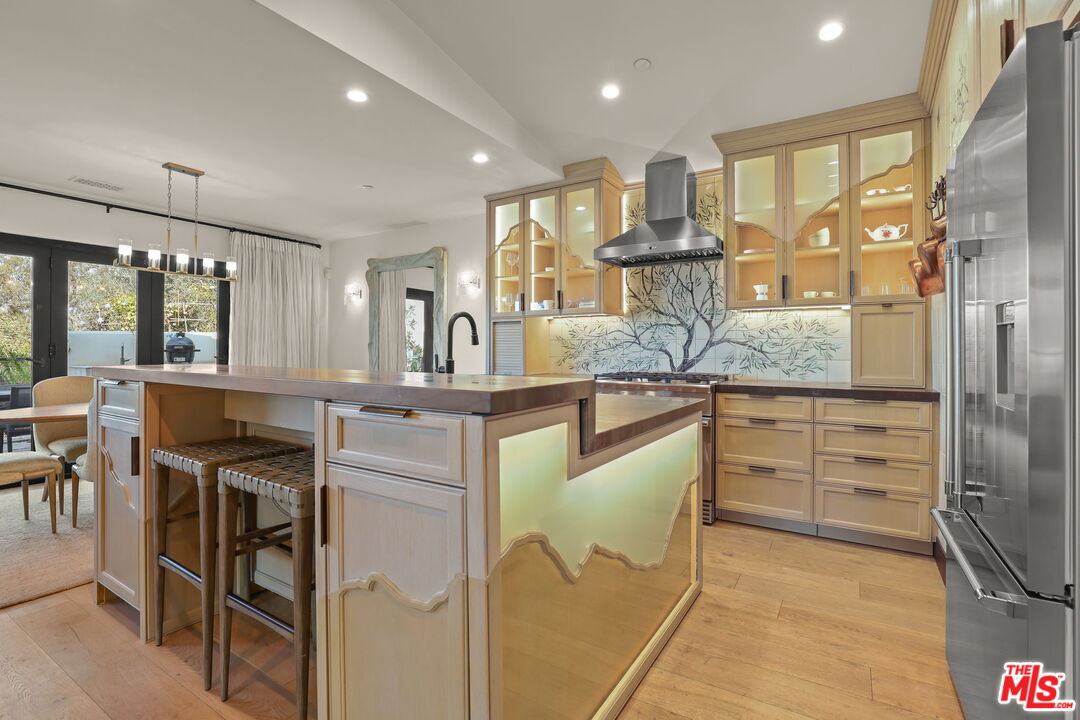 2835 Oak Point Drive Los Angeles, CA 90068 - Photo 10 of 50 a kitchen with kitchen island granite countertop a sink cabinets and stainless steel appliances