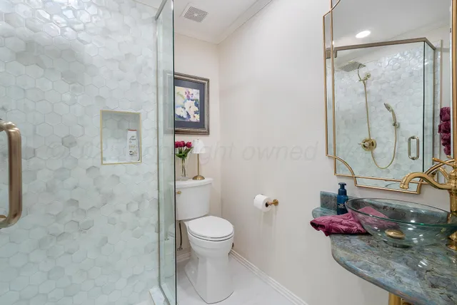a bathroom with a toilet sink and shower