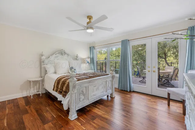 a bed sitting in a spacious bedroom next to a window
