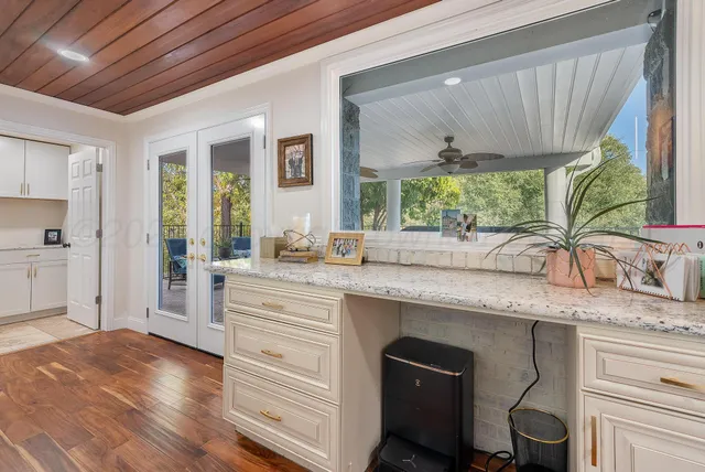 a kitchen with granite countertop a sink a counter space appliances and cabinets