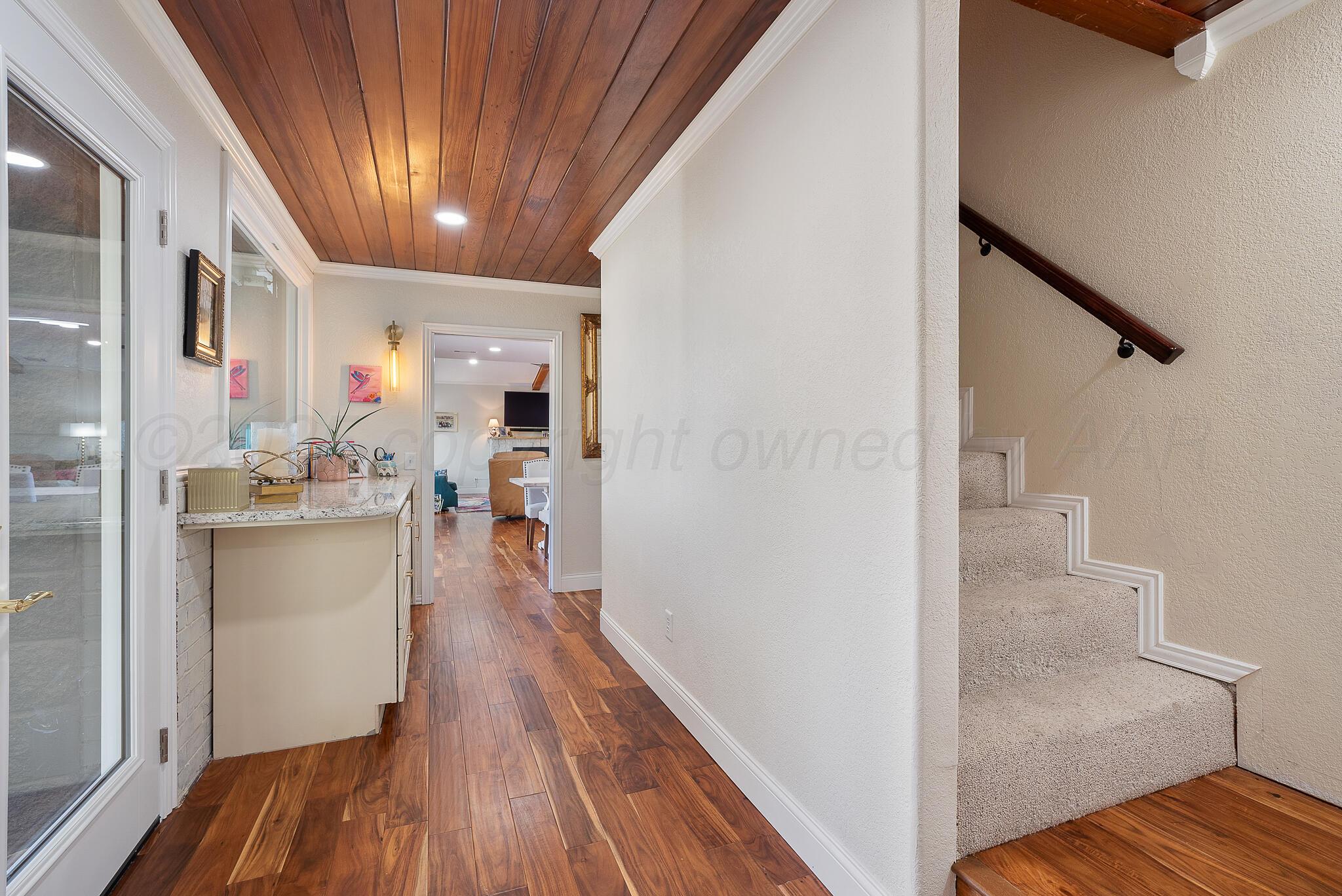 110 Caprock Lane Amarillo, TX 79118 - Photo 20 of 46 a view of a hallway view with wooden floor and staircase