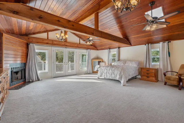 a spacious bedroom with a bed and a chandelier