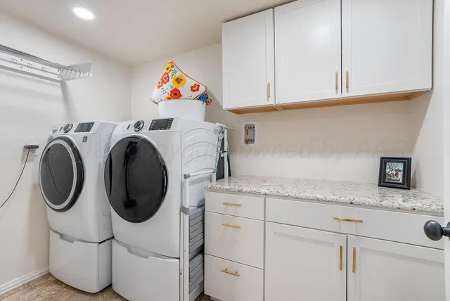 a utility room with sink dryer and washer