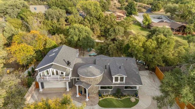 an aerial view of residential houses with yard