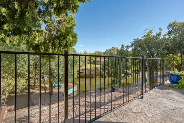 a view of a street with a building and trees in the background