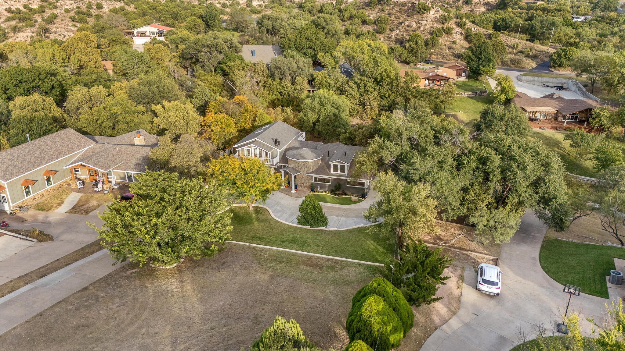 110 Caprock Lane Amarillo, TX 79118 - Photo 40 of 46 an aerial view of a house with a yard and a large tree
