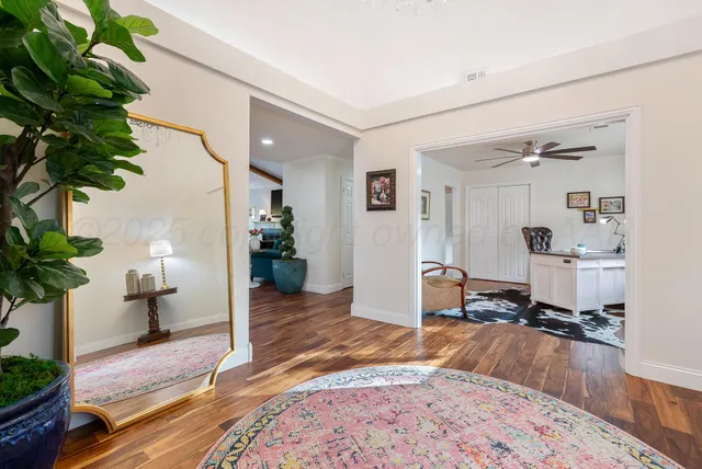 a living room with furniture and a potted plant