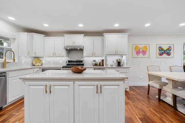 a kitchen with cabinets a sink and appliances