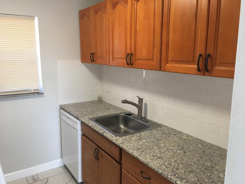 450 Southwest 2nd Avenue, Unit 2080 Boca Raton, FL 33432 - Photo 6 of 14 a kitchen with a sink and cabinets