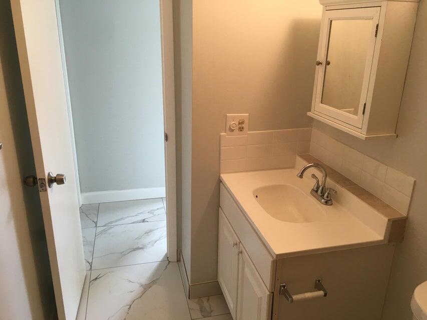 450 Southwest 2nd Avenue, Unit 2080 Boca Raton, FL 33432 - Photo 9 of 14 a bathroom with a sink and mirror with toilet