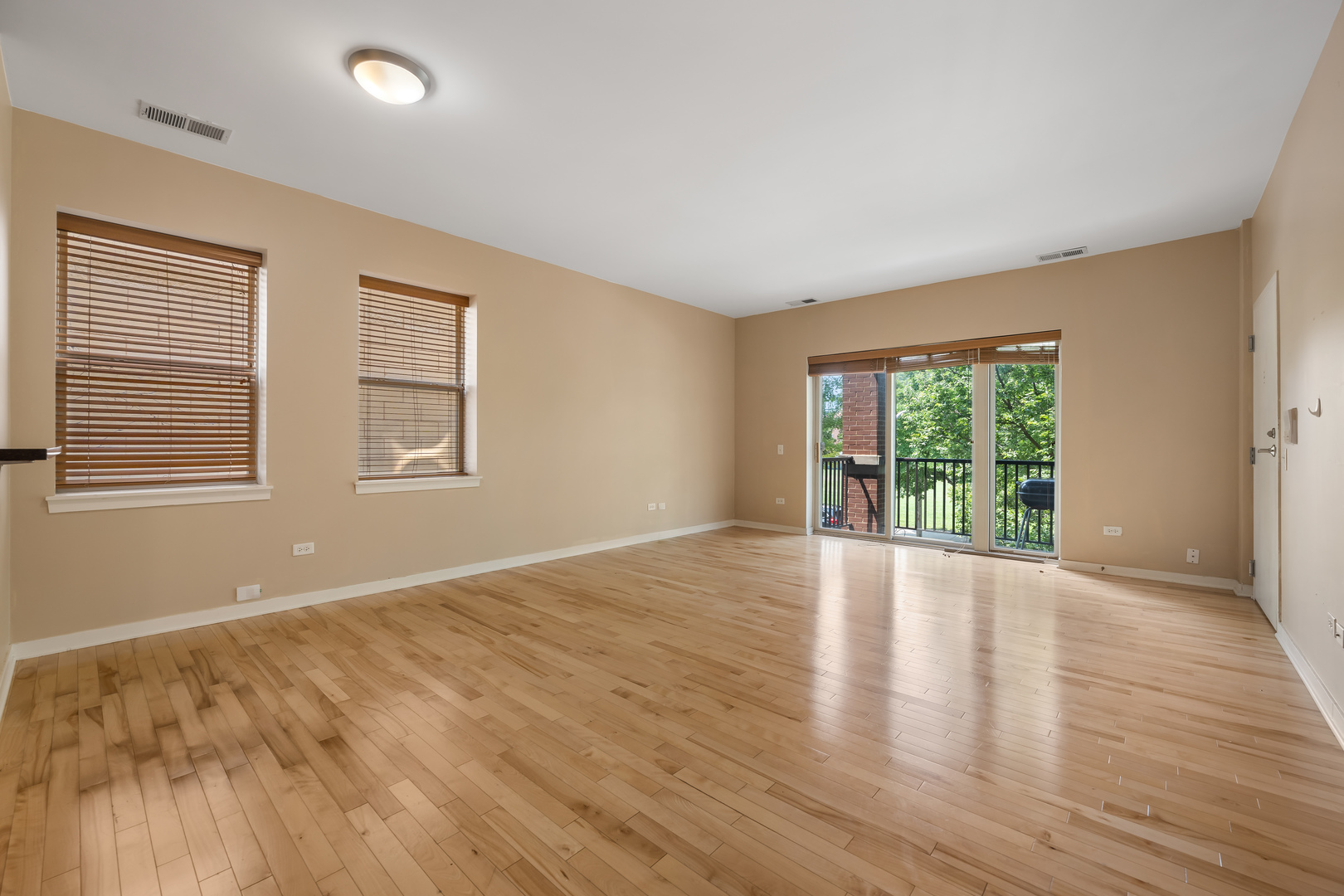 907 South Lytle Street, Unit 201 Chicago, IL 60607 - Photo 6 of 28 a view of an empty room with wooden floor and a window