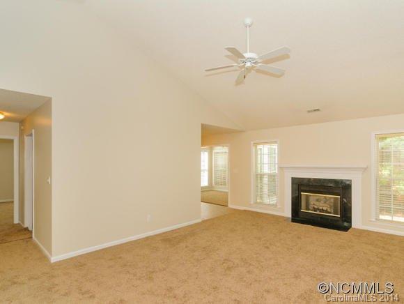25 Forest Berry Road Fletcher, NC 28732 - Photo 9 of 24 a view of a livingroom with a fireplace and ceiling fan