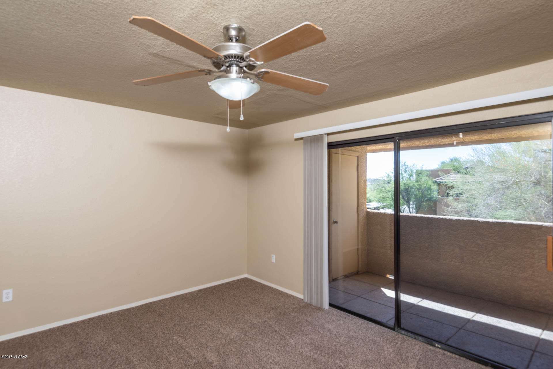 7255 East Snyder Road, Unit 8205 Tucson, AZ 85750 - Photo 7 of 23 an empty room with windows and fan