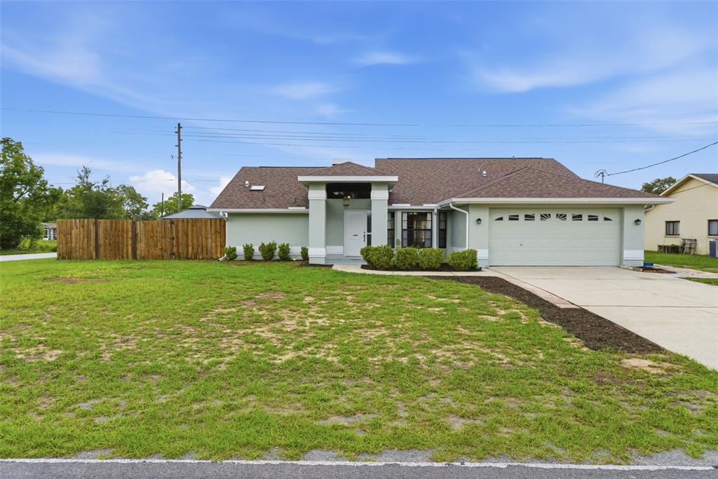 4966 Keysville Avenue Spring Hill, FL 34608 - Photo 1 of 48 a front view of a house with a yard