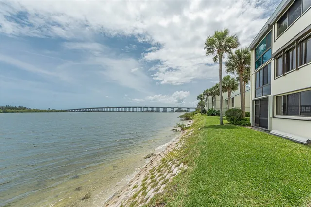 a view of a lake with a big yard and a large window
