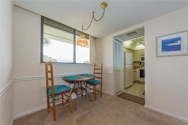a view of a room with furniture and windows
