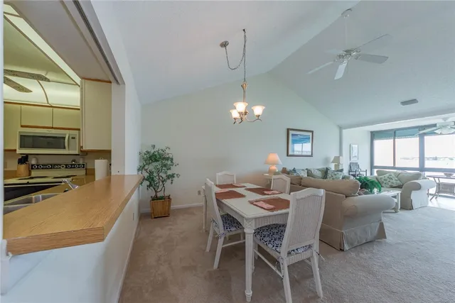 a dining room with furniture a chandelier and window