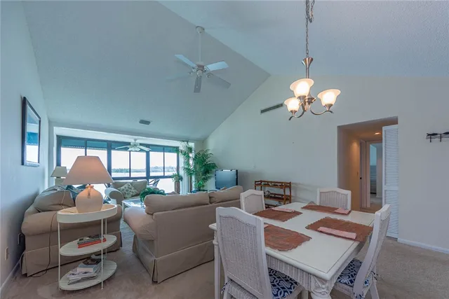 a living room with furniture a chandelier and a window