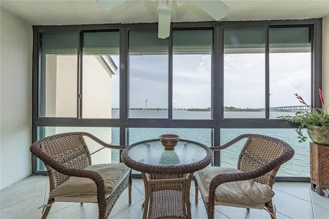 a balcony with table and chairs