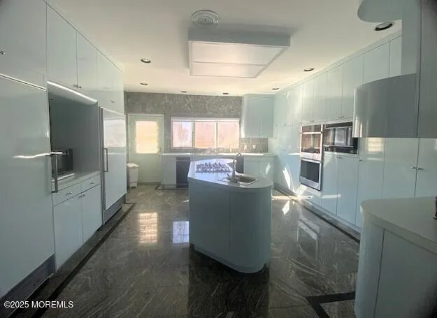 a kitchen with counter top space and stainless steel appliances