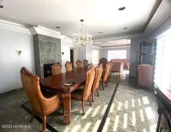 a view of a dining room with furniture and chandelier