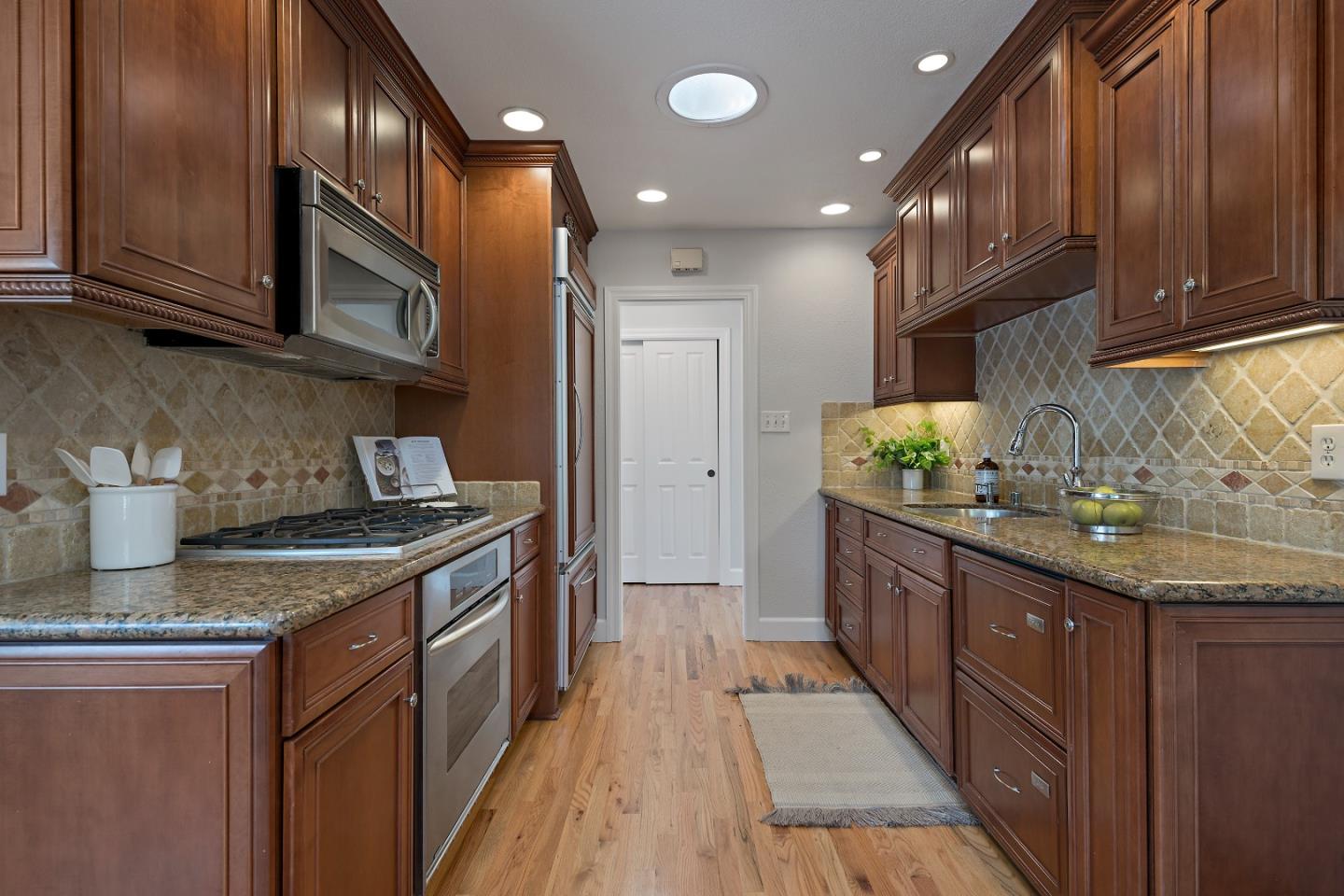 16131 Jacaranda Way Los Gatos, CA 95032 - Photo 12 of 30 a kitchen with granite countertop stainless steel appliances and wooden cabinets