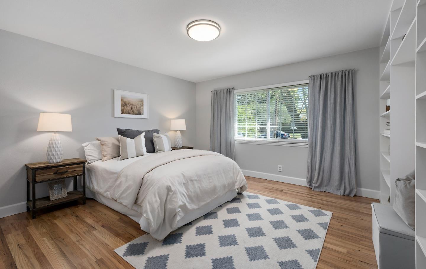 16131 Jacaranda Way Los Gatos, CA 95032 - Photo 16 of 30 a bedroom with a bed and a lamp