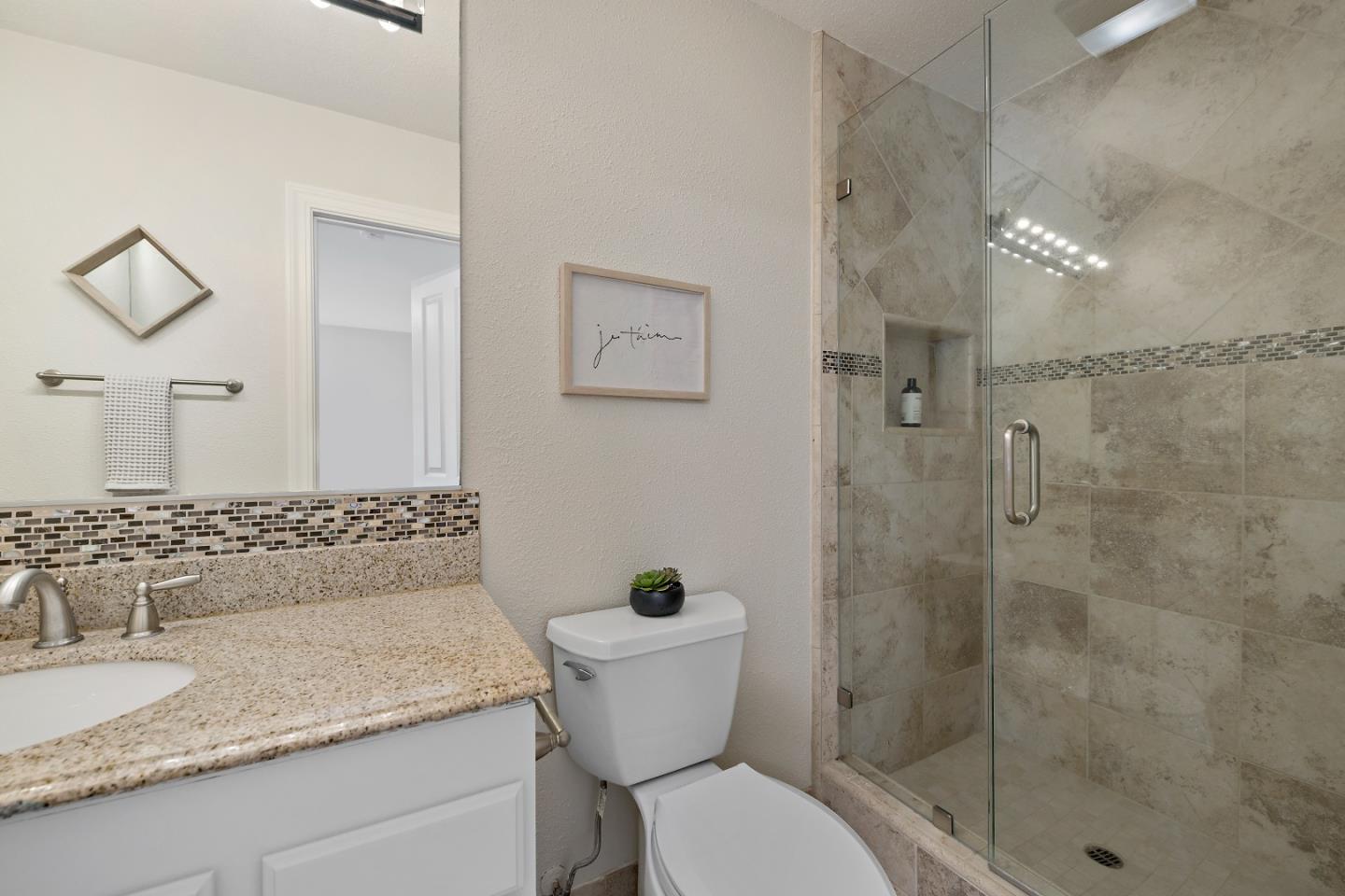 16131 Jacaranda Way Los Gatos, CA 95032 - Photo 18 of 30 a bathroom with a granite countertop sink a toilet and shower