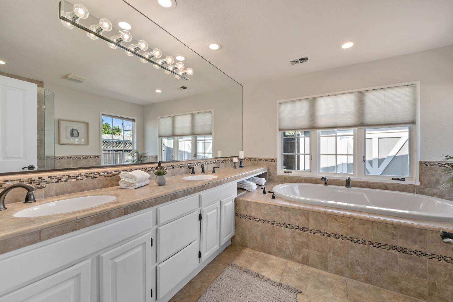 16131 Jacaranda Way Los Gatos, CA 95032 - Photo 26 of 30 a spacious bathroom with a sink double vanity mirror and bathtub