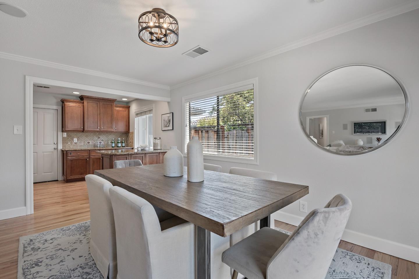 16131 Jacaranda Way Los Gatos, CA 95032 - Photo 8 of 30 a view of kitchen island with granite countertop a sink dishwasher a fireplace with wooden floor and dining table
