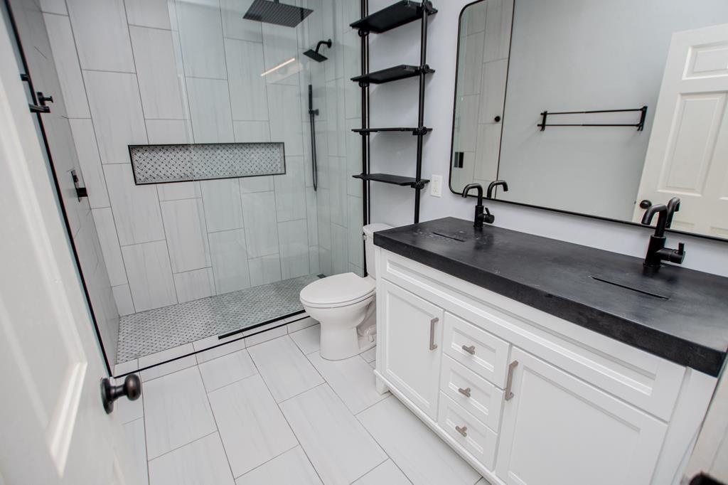 75 Cash Lane Bremen, GA 30110 - Photo 44 of 92 a bathroom with a granite countertop sink a toilet and a shower